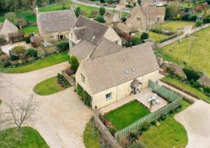 an aerial view of a large house with a yard at Country Cottage in the Heart of the Cotswolds! in Farmington