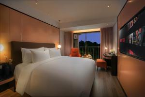 Ένα ή περισσότερα κρεβάτια σε δωμάτιο στο Aurora Oriental Hotel