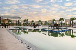 a rendering of a resort pool with tables and chairs at Sapphire Blue in Bhopal