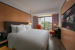 Ένα ή περισσότερα κρεβάτια σε δωμάτιο στο Aurora Oriental Hotel
