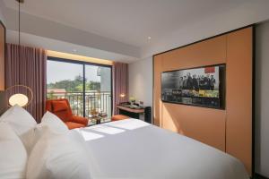 Ένα ή περισσότερα κρεβάτια σε δωμάτιο στο Aurora Oriental Hotel