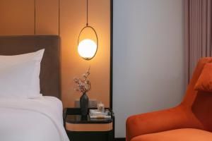 Ένα ή περισσότερα κρεβάτια σε δωμάτιο στο Aurora Oriental Hotel