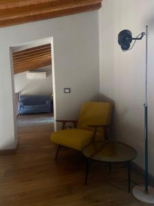 a yellow chair and a lamp in a room at The Barn among olive trees in Ponte a Ema +16 photos