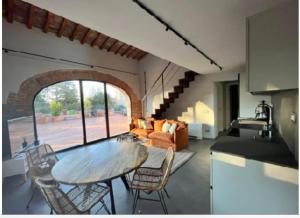 a kitchen and living room with a table and chairs at The Barn among olive trees in Ponte a Ema