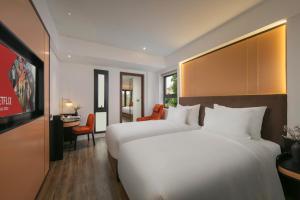 Ένα ή περισσότερα κρεβάτια σε δωμάτιο στο Aurora Oriental Hotel