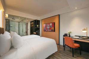 Ένα ή περισσότερα κρεβάτια σε δωμάτιο στο Aurora Oriental Hotel