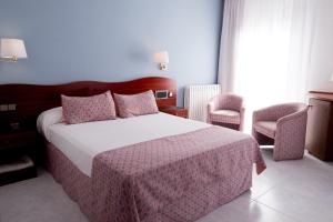 Postel nebo postele na pokoji v ubytování Hotel Plaça