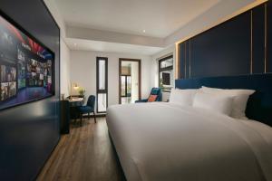 Ένα ή περισσότερα κρεβάτια σε δωμάτιο στο Aurora Oriental Hotel