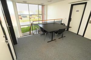 a conference room with a black table and chairs at Sport & Academy in Farsø
