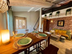 a dining room with a table and a couch at La maison d'Eddy et Caro aux Portes du Verdon in Trigance
