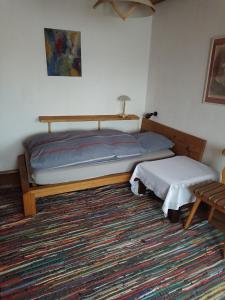 a bedroom with a bed and a table and a rug at Haus am Berg in Wertheim
