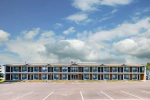 a large building with a parking lot in front of it at Quality Inn & Suites Garden of the Gulf in Summerside