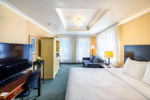 a hotel room with a large bed and a couch at Quality Inn & Suites Garden of the Gulf in Summerside