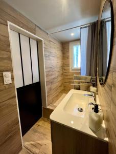 a bathroom with a sink and a mirror at La maison d'Eddy et Caro aux Portes du Verdon in Trigance +40 photos