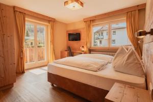 Postel nebo postele na pokoji v ubytování Naturhotel Sonnenhof