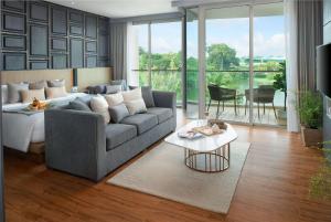a living room with a couch and a table at Wyndham Grand Nai Harn Beach Phuket in Nai Harn Beach