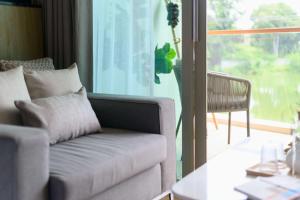 a living room with a couch and a table at Wyndham Grand Nai Harn Beach Phuket in Nai Harn Beach