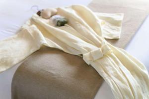 a dress with a bow on the waist of a woman at Wyndham Grand Nai Harn Beach Phuket in Nai Harn Beach