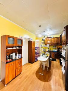 a large kitchen with wooden cabinets and a white table at Feel at Home Polomolok WiFi 300mbps Netflix 75in TV in Polomolok +8 photos