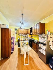 a kitchen with a table in the middle of it at Feel at Home Polomolok WiFi 300mbps Netflix 75in TV in Polomolok