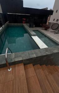 a swimming pool with a hose in a building at Flat alto padrão Intermares in Cabedelo