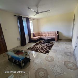 a living room with a couch and a rug at Wema centre apartment in Gatunga