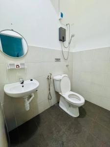 a bathroom with a toilet and a sink at Zalins CozyHome 3BR - Double Storey Terrace in Kepala Batas
