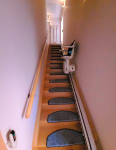 a stairway in a building with a hand rail at Ferienwohnung in Petze in Sibbesse