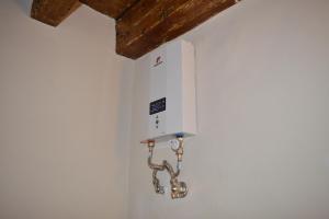 a pipe hooked up to a wall in a room at Lemonia apartment Old Town in Corfu