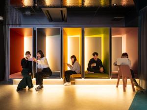 東京にあるOCICA OSHIAGE TOKYO by R HOTELの店頭に座る人々
