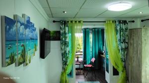 a room with some paintings on the wall at Villa Camille A8A in Grand-Baie