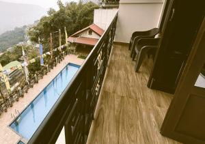 a balcony with a view of a swimming pool at Hotel Tempo Heritage Resort In Gangtok in Gangtok