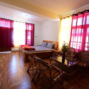 a living room with a bed and a table and chairs at Spitihome homestay in Kaja