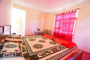 two twin beds in a room with a window at Spitihome homestay in Kaja +3 photos