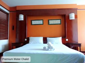 a bedroom with a large bed with two towels on it at Alpine Premium Water Chalet 2 in Port Dickson