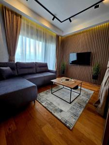 a living room with a couch and a coffee table at Centar Balkan Square in Zlatibor