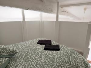 a bedroom with a bed with a towel on it at Langon centre - Wi-Fi - 1 à 4 voyageurs in Langon
