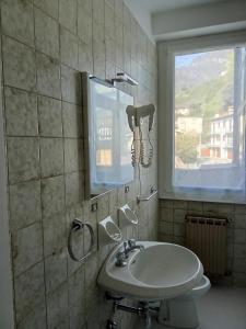 a bathroom with a sink and a mirror and a window at Locanda dei pescatori in Domaso