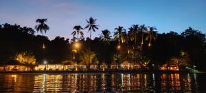 vista di un resort dall'acqua di notte di Bebeladan Beach Eco-Resort, The Last Indigenous Corner a El Nido