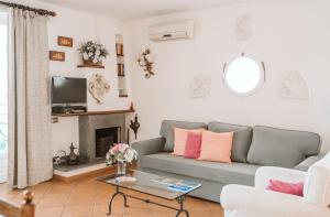 a living room with a gray couch and a fireplace at Cilento Rooftop in Agropoli