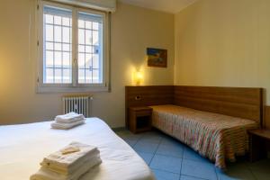 Postel nebo postele na pokoji v ubytování Hotel Ideale