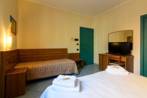 Postel nebo postele na pokoji v ubytování Hotel Ideale
