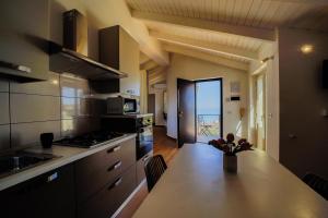 A kitchen or kitchenette at San Martino Holiday Apartments