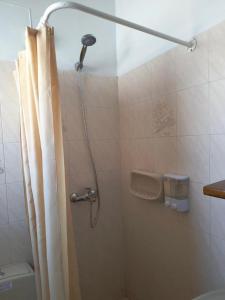 a shower with a shower curtain in a bathroom at Liber-Mar apartments in Petra +54 photos