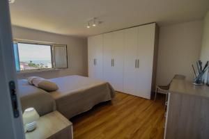 A bed or beds in a room at San Martino Holiday Apartments