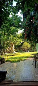 a park with a picnic table and trees and grass at Villa THỦY NGUYÊN in Bình Thủy