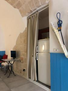 a kitchen with a refrigerator and a table at casa Pavone in Monopoli