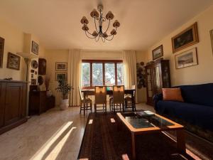 a living room with a blue couch and a table at Casa Genny in Ventimiglia