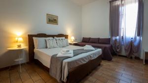 a bedroom with a bed and a couch at Laghi di Faldo in Montone