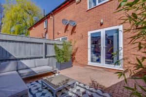 Casa de ladrillo con sofá y patio en Hot Tub, Private Parking, King Bed, Beach luxury, en Cleethorpes